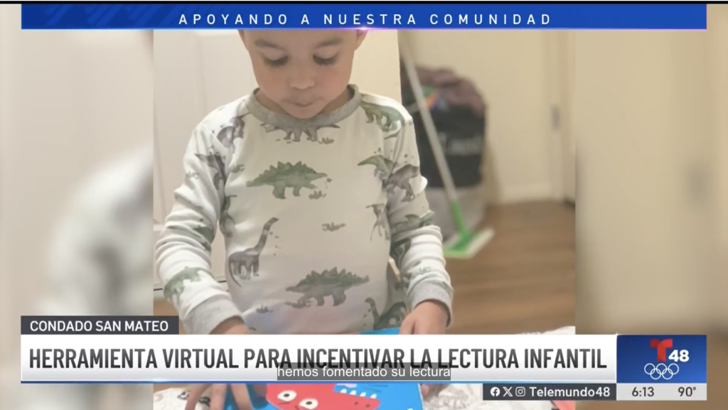 screen shot of a preschool-aged child wearing pajamas and looking at a book